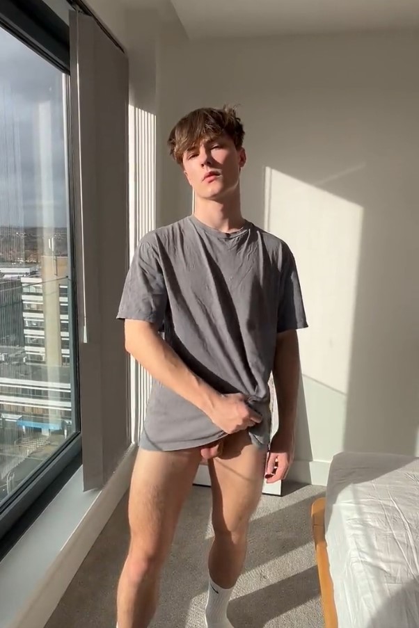 KodyTwink (@kodytwink) tiktok gay in piedi con indosso una maglietta grigia